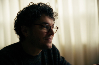 A man sitting at a table looking off to the side